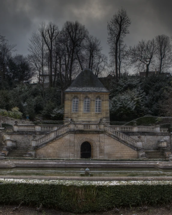 an old mansion sitting in front of trees