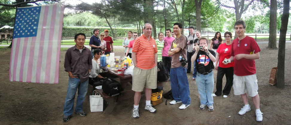 a group of men standing around each other near trees