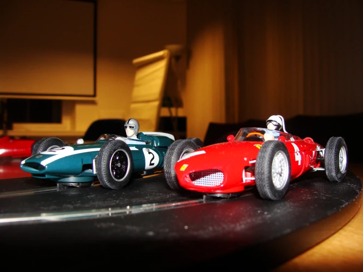 two model racing cars, one red and one blue