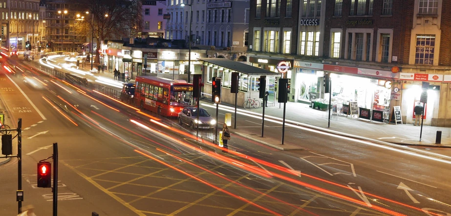 two double decked buses and traffic on a city street