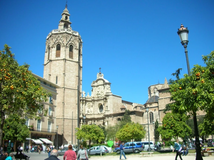 there are many people walking and sitting around this town square