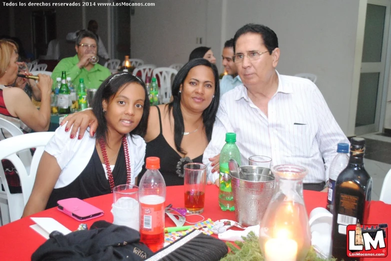 two woman and two men posing at an outdoor table