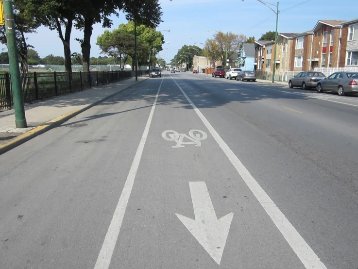 a empty street with two white arrows on the street