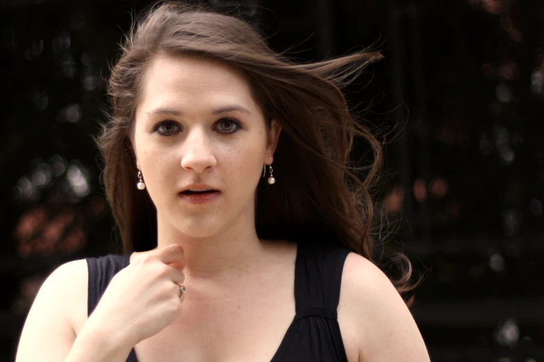 a woman in black top with some big diamonds