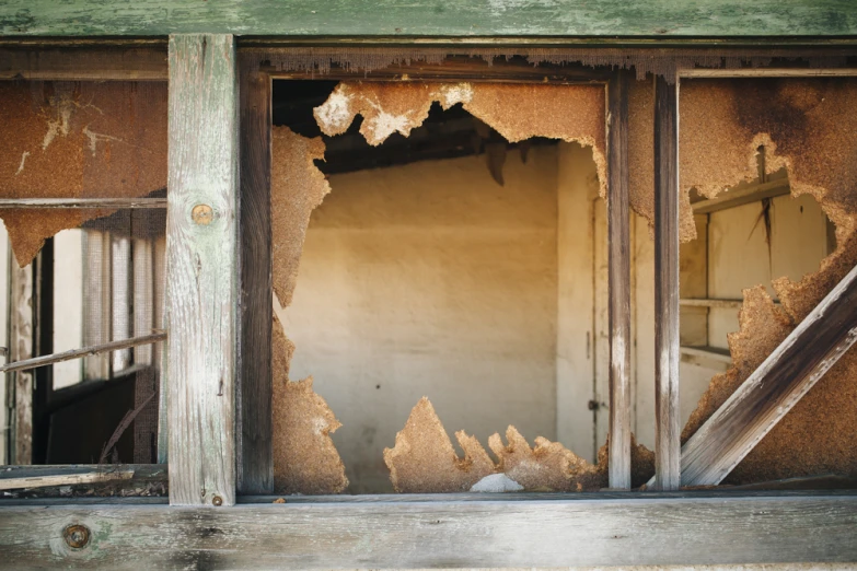 a demolished building with window frames and walls