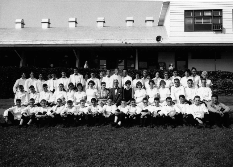 an old picture of boys and women in uniform outside