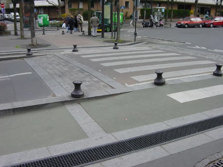 a cross walk in a small town surrounded by tall buildings