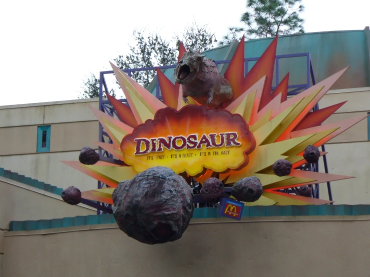 large dinosaurs are displayed on a sign at the amut park