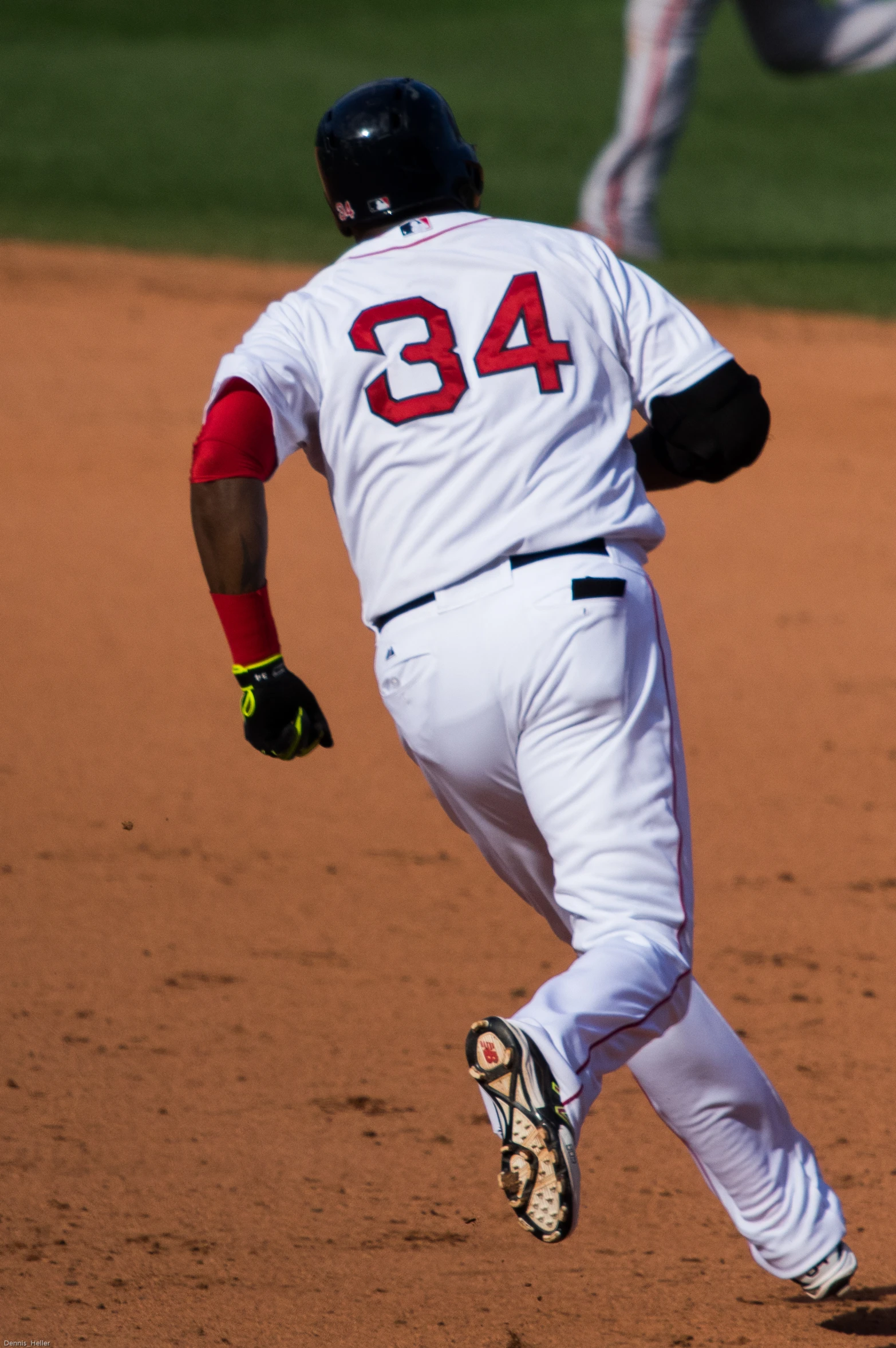 a baseball player running on a base during a game