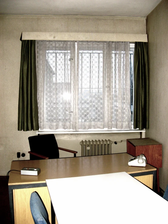 a white table in front of a window with curtains