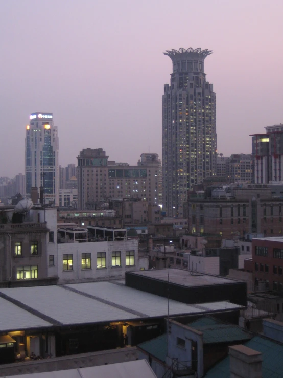 the cityscape is seen during twilight with tall buildings