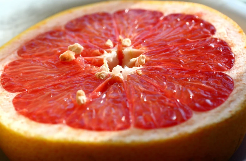 a gfruit sits in the sun on a plate