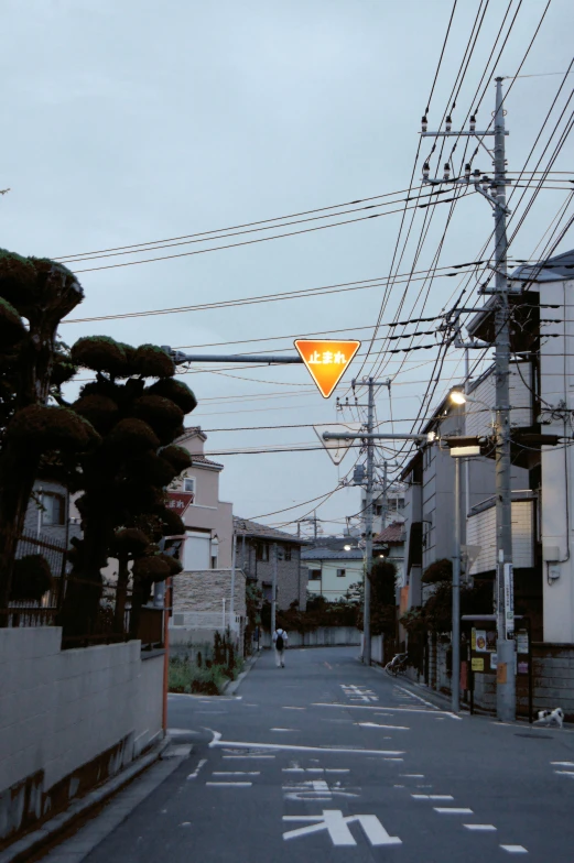 an intersection with no traffic, and a lighted street sign