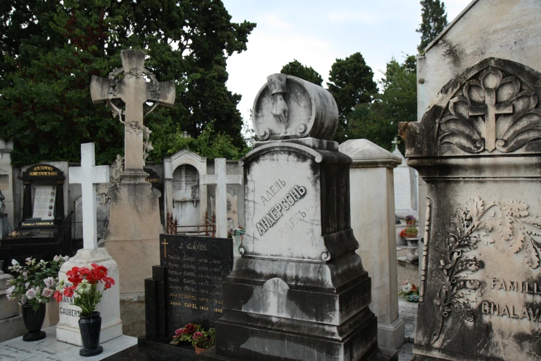 there are flowers and headstones on this graveyard