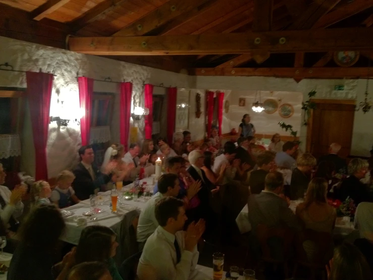 a group of people sitting at tables in a restaurant