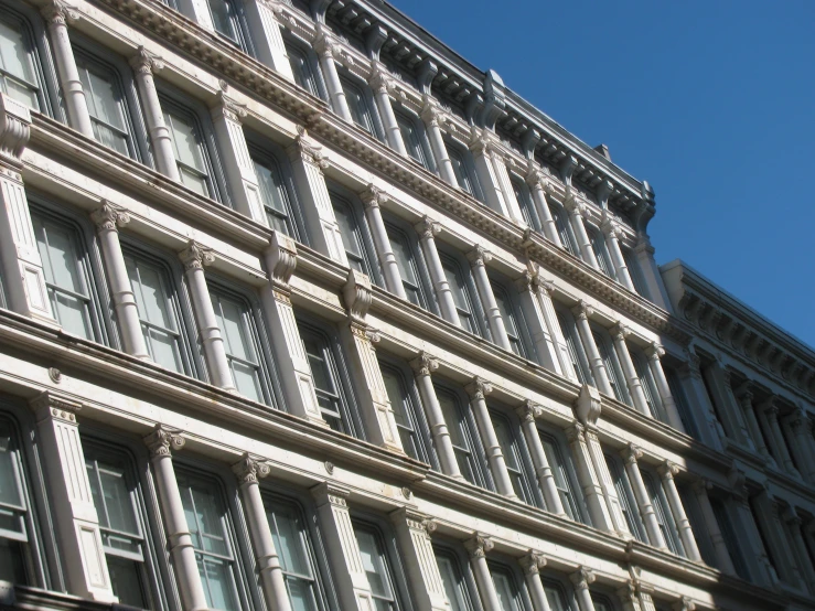 the corner view of a building with many windows