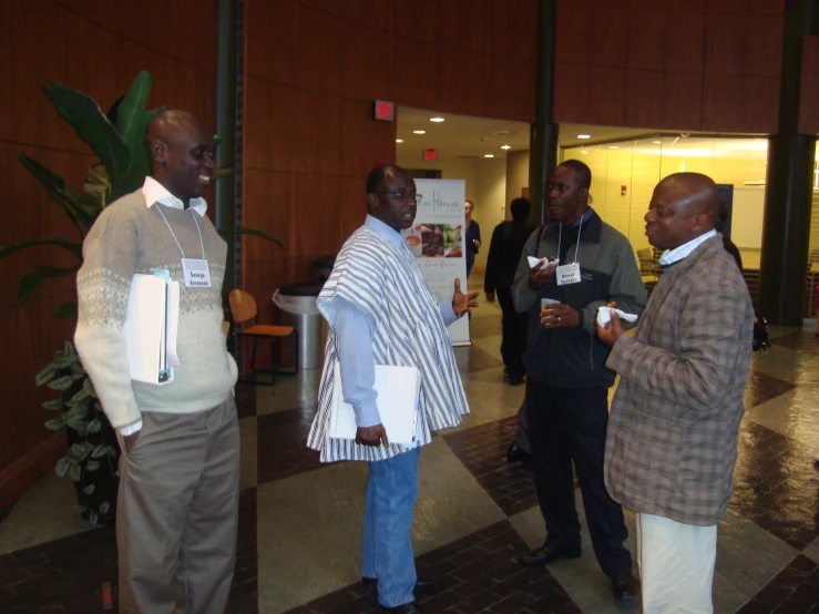 group of people with business related items talking in indoor area