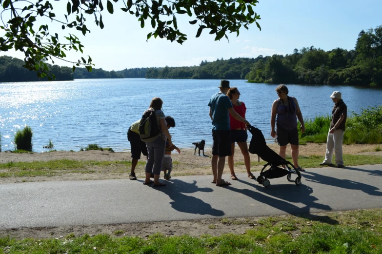 a group of people standing on the edge of a lake