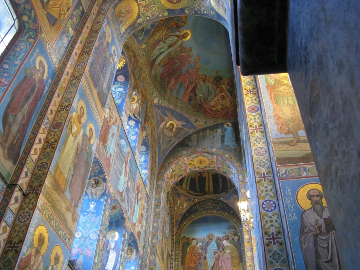 a very colorful wall and ceilings with paintings on it