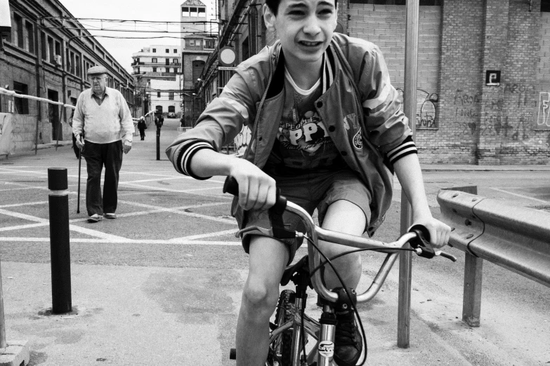 a black and white po of someone riding their bike down the street