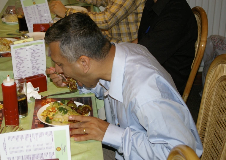 a man eating a large meal with an assortment of food items