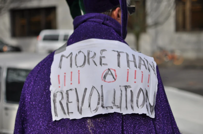 someone dressed in a purple coat and wearing a graduation hat has some fake fake words on it