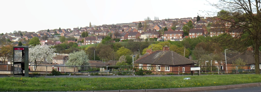 a residential area on a hill with houses and trees