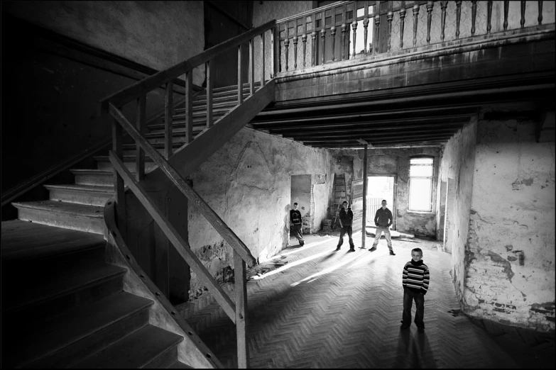 black and white pograph of a boy standing in a room