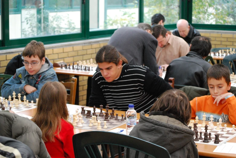 a person sitting down while playing chess