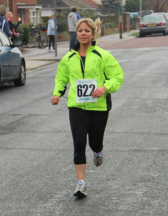 a woman running in a marathon on the street