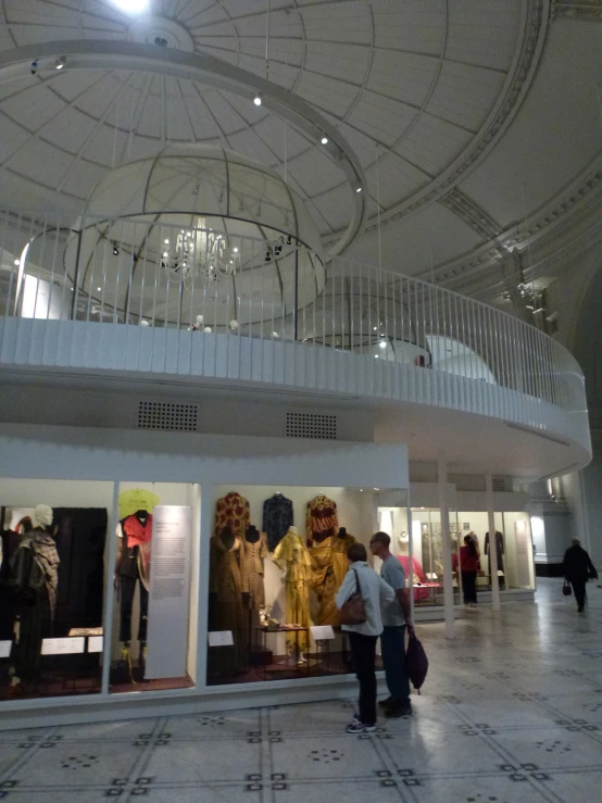 two men walking by a giant white and gray room