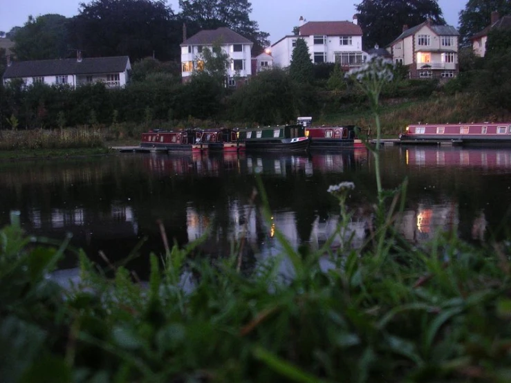 boats on the water next to some homes