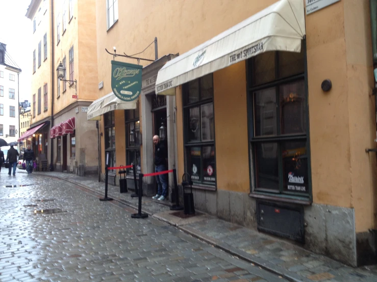 a street that has people walking by some storefronts