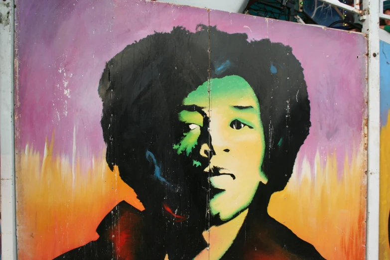 a graffiti painting of a man with an afro in the background