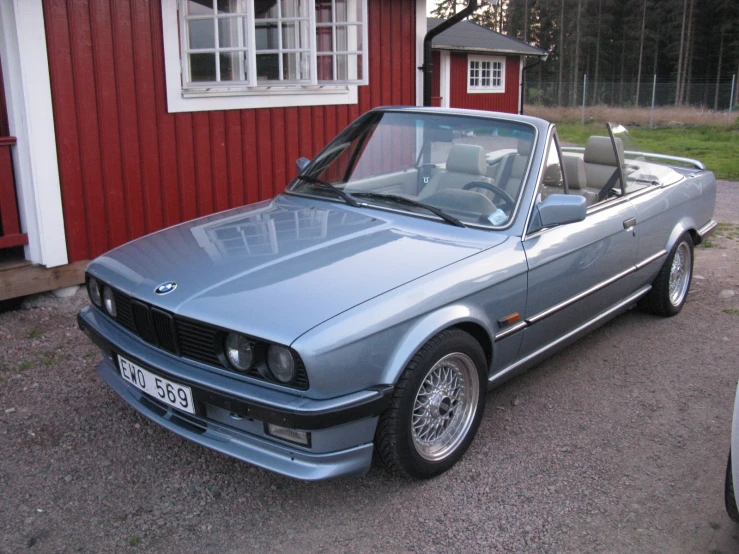 a grey car parked on the side of a driveway