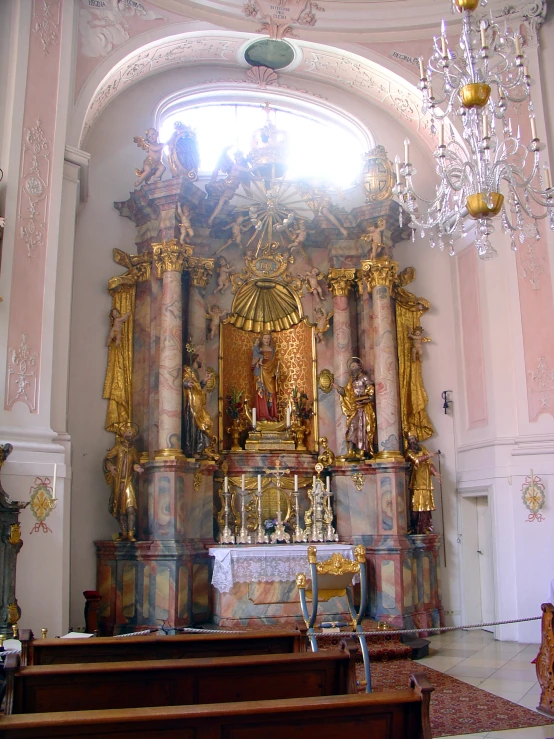 ornate ornate gold and white statue and chandelier