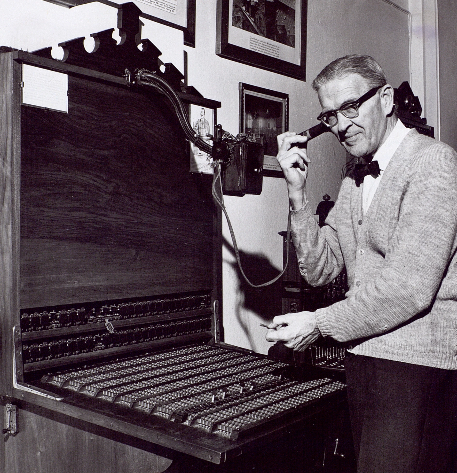 a man sitting in front of a pipe organ