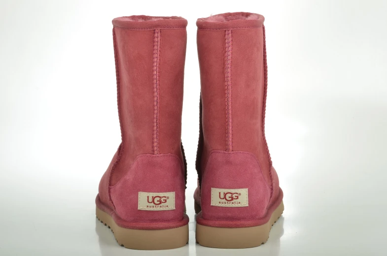 a pair of pink ugg boots on a white surface