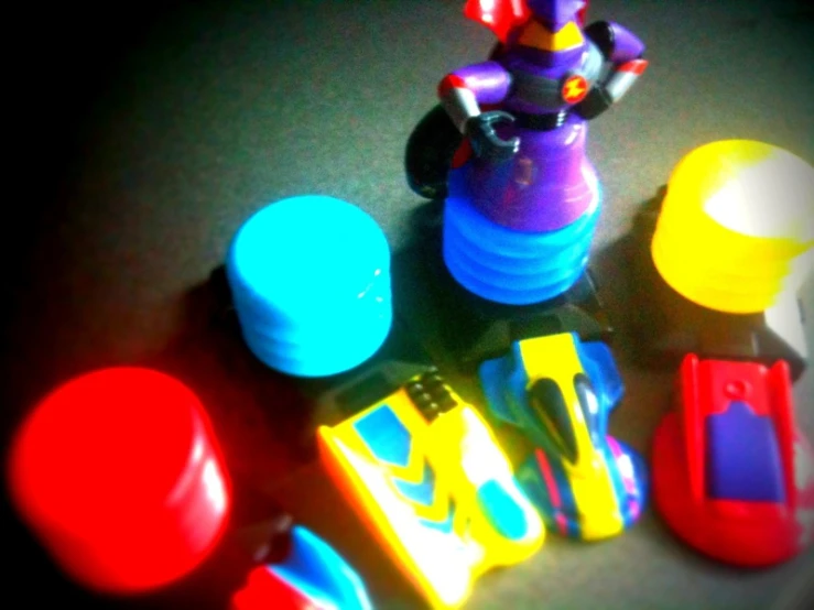 a toy clown surrounded by assorted items like pens and toothbrushes