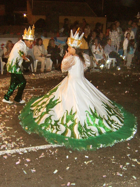 two men in costumes on a dance floor at night