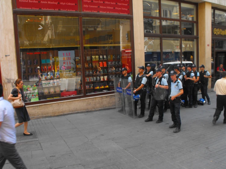 a group of police officers stand in front of a store