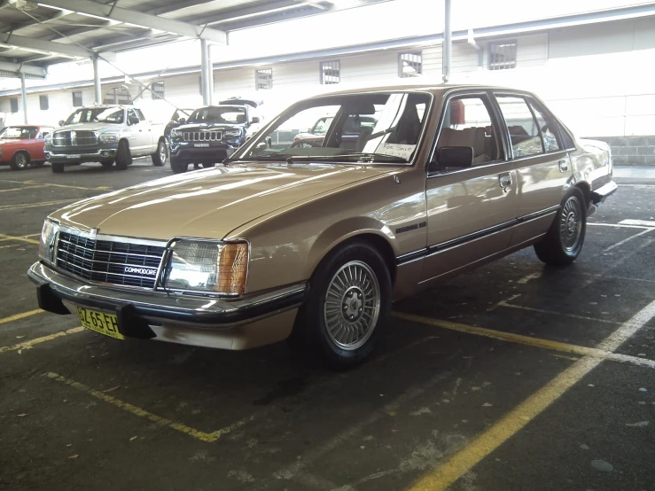 a tan sedan parked in a parking lot