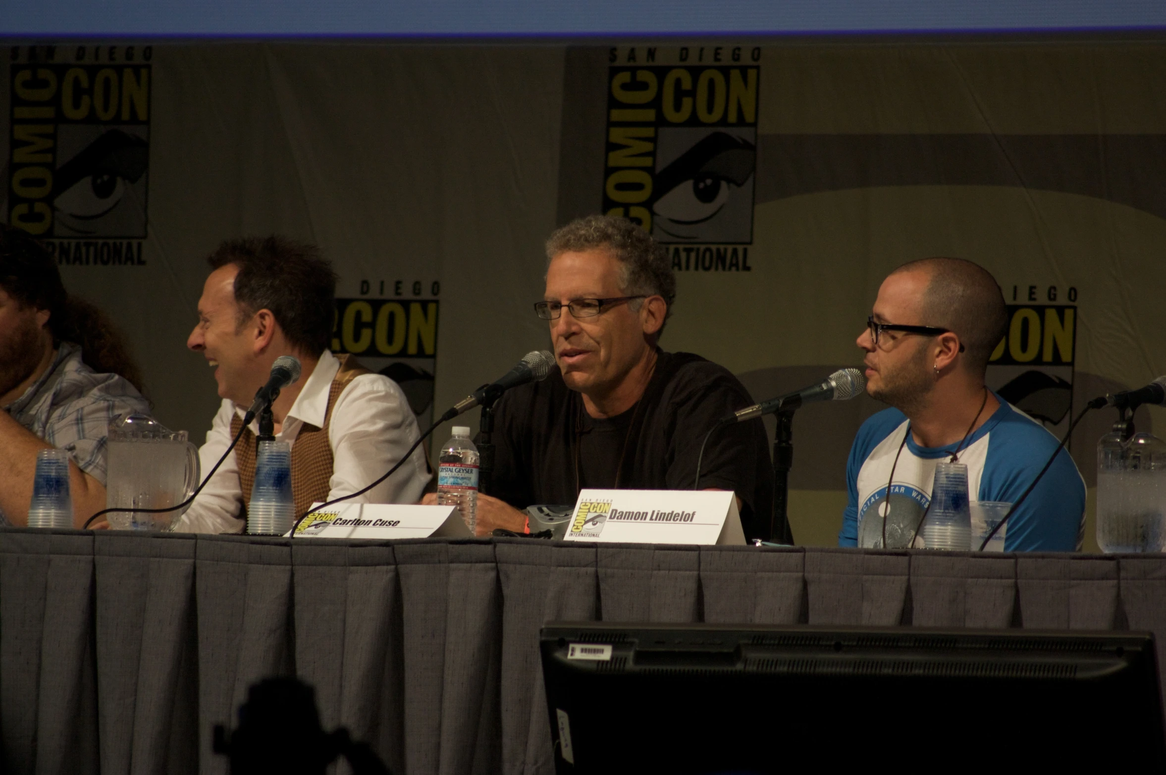 actors at a panel during a comic convention