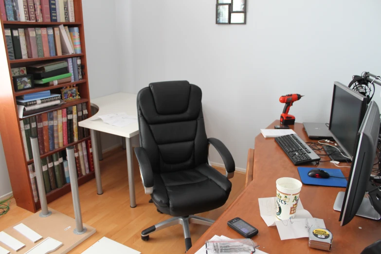 this is a office desk with a large computer chair