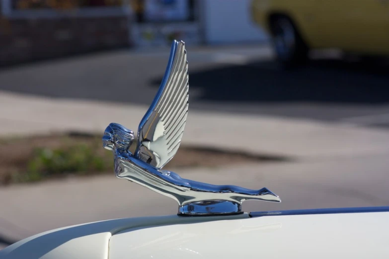 there is a logo on the hood of a vintage car