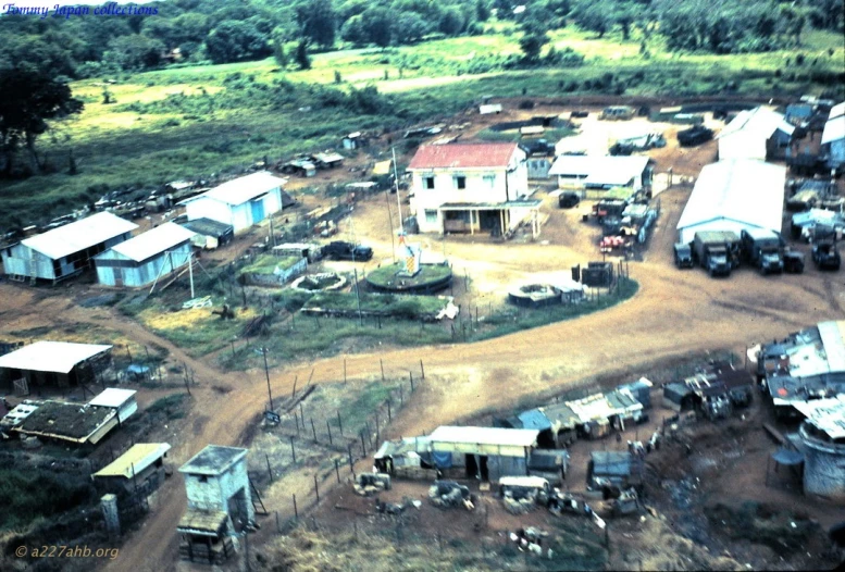 a small village with several large trucks in the background