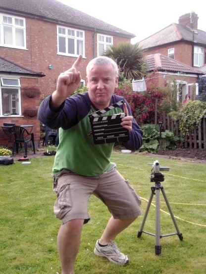 a man standing next to a camera while holding a camera