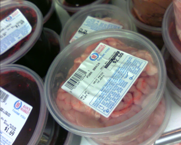 some containers of meat and beans on a counter