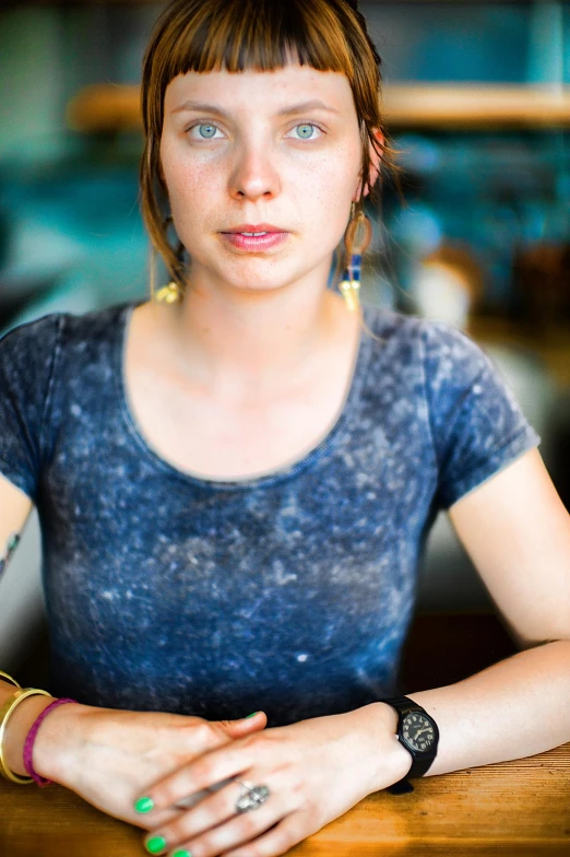 woman with dark short hair wearing celets