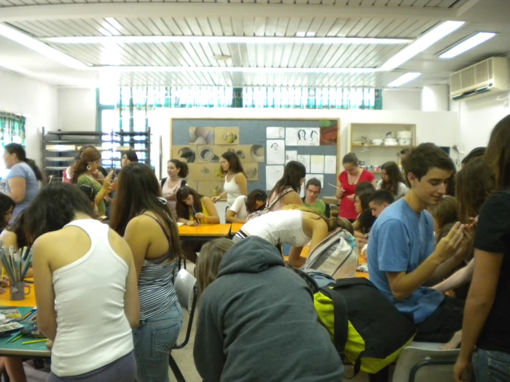 people standing around and sitting at tables